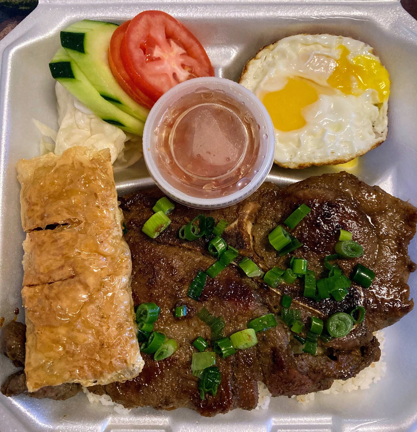 The 777 Rice Special at Okemos’ Pho 777 comes with a sampling of Vietnamese dishes, including grilled pork steak, egg meatloaf, a fried egg and shrimp and pork wrapped in fried tofu skin. Drizzle fish sauce over the top to elevate the already intoxicating flavors.