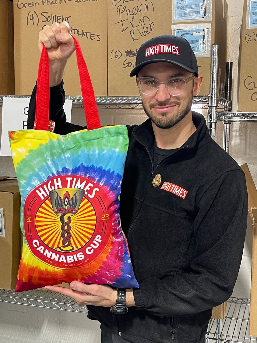 Mark Kazinec, High Times’ vice president of events and competitions, poses with a tie-dye judging kit filled to the brim with THC-infused goodies.