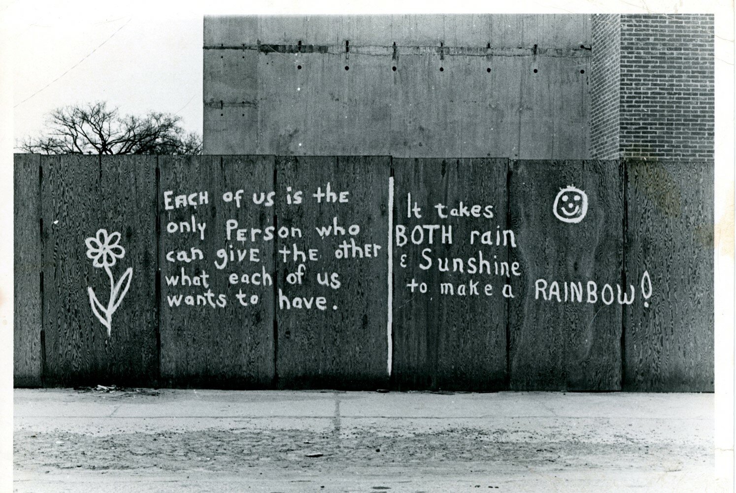 Graffiti on plywood construction barriers near Lansing Community College’s downtown campus, photographed in 1971. The mural was adapted into a wedding invitation for Bill and Mary Castanier in 1972.