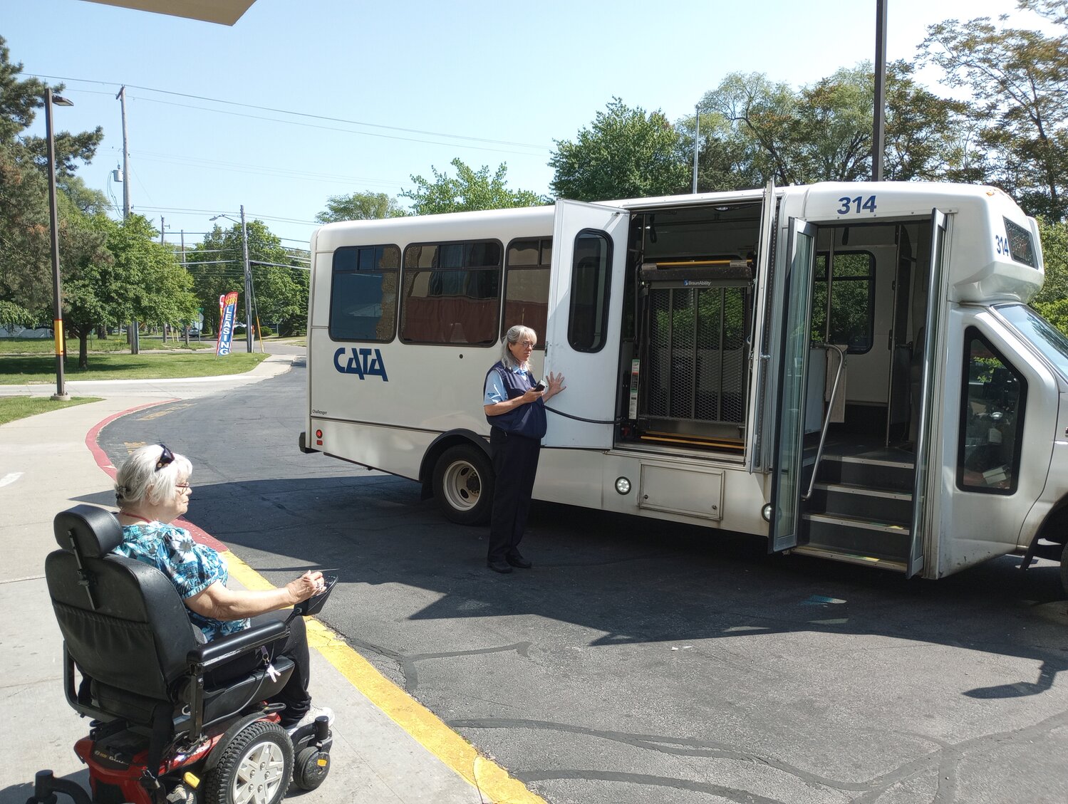 Constance Hart, 79, who lives in an apartment on West Jolly Road in Lansing, prepares to board a SpecTran bus with the assistance of driver Heidi Beavers. Hart was heading to a local church.