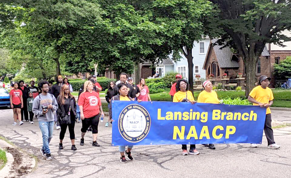 Representatives from the Lansing branch of the NAACP march in the annual Lansing Juneteenth Celebration African American Parade in 2019.