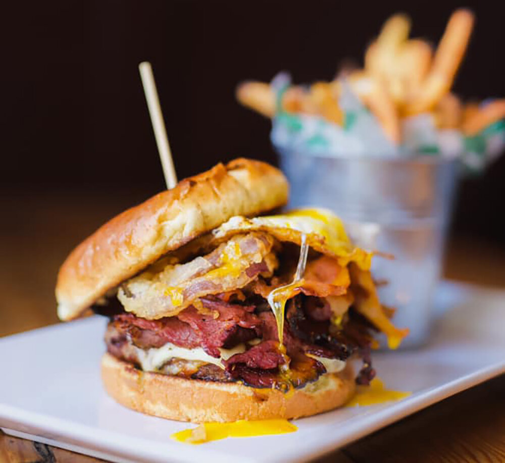 Cask and Co. offers an array of elevated burgers, such as its Spartan Burger, which is topped with pastrami, bacon, a fried egg, an onion ring and pepper jack cheese.