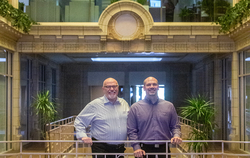 Paul Gentilozzi and his son John pose in the lobby of the Atrium Building, which will be the gateway to the 25-story Tower on Grand from Washington Square.