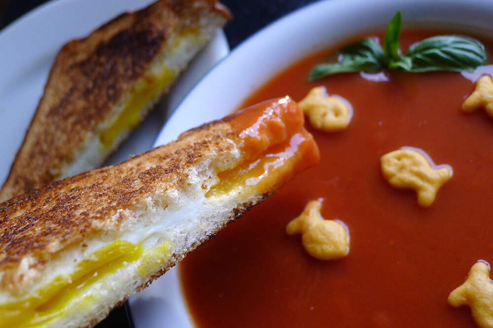 Grilled cheese and tomato soup is an iconic and cost-effective lunch combo. Consider elevating this classic dish by cooking an egg in the center of the sandwich.