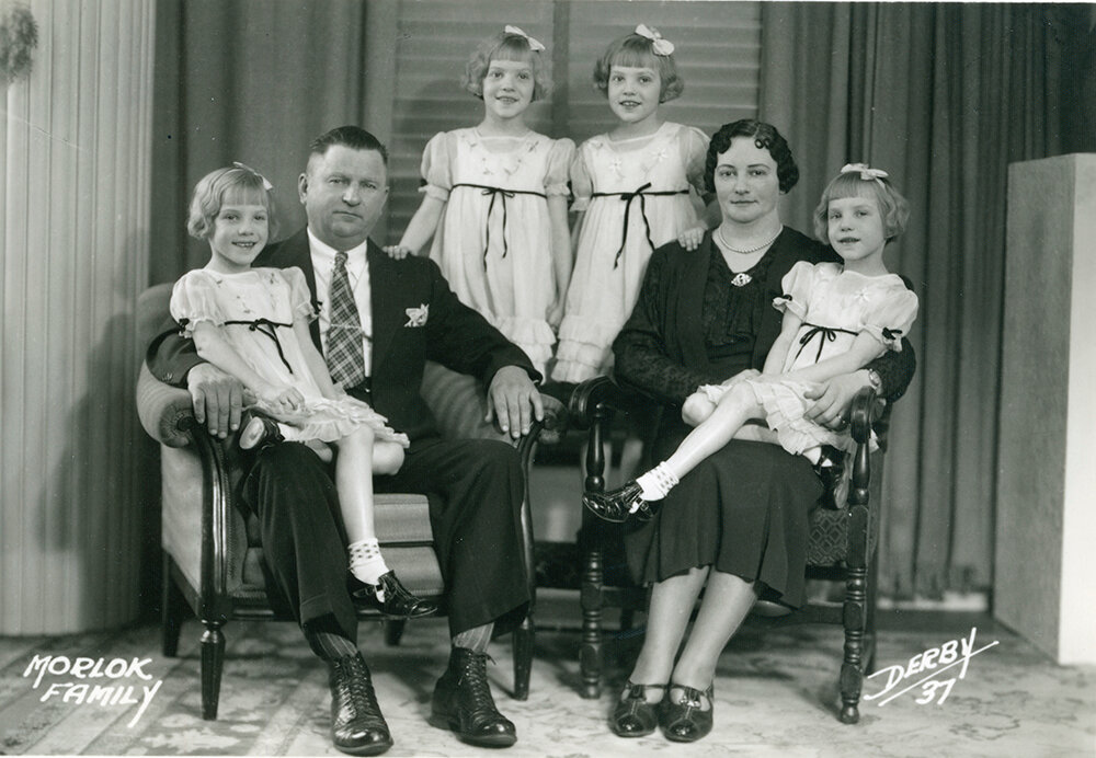 Carl and Sadie Morlok pose for a family portrait with their quadruplet daughters, Edna, Wilma, Sarah and Helen, in 1937.
