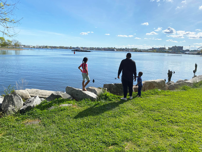 A family at land's end at India Point Park in Providence, at the convergence of Narragansett Bay.