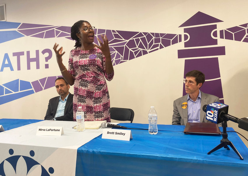 Nirva LaFortune, center, responding to a question at the Aug. 4 forum sponsored by RICAREs. Gonzalo Cuervo, left, and Brett Smiley, right, listen.