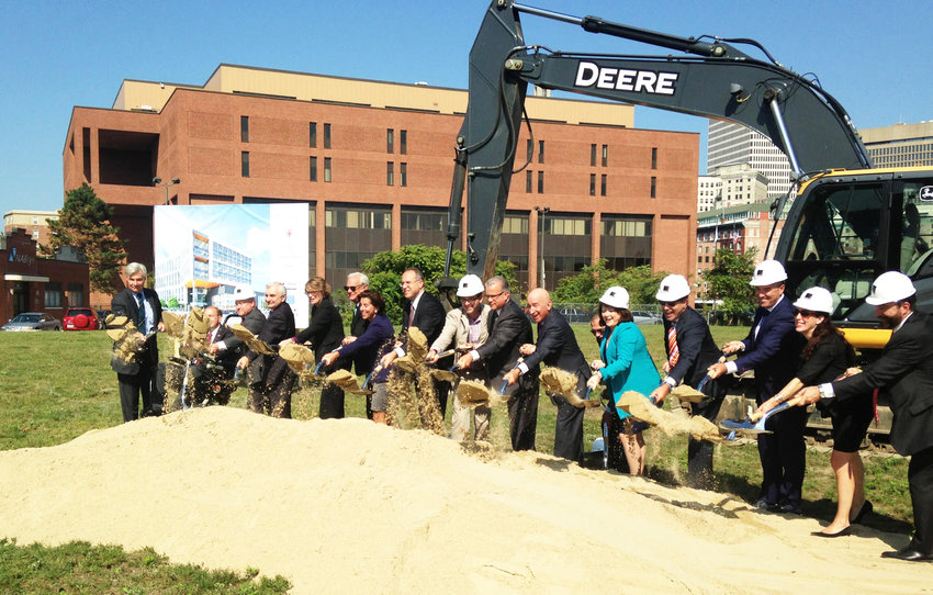 Dignitaries throw ceremonial shovels of dirt as part of the official groundbreaking at the Wexford Innovation Center in September of 2017.