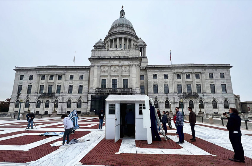 The display of a pallet shelter on the State House plaza, erected by community advocates, including Professor Ed Hirsch of Providence College.