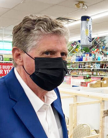 Gov. Dan McKee, at a pharmacy in Olneyville in 2021, promoting flu shots.