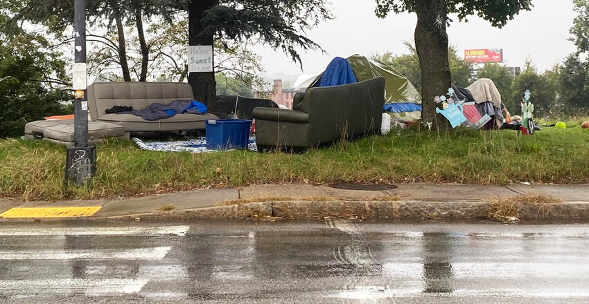 It was a cold and rainy day at the homeless encampment on Orms Street in Providence, across from the R.I. Department of Health and the R.I. Department of Administration buildings. An unhoused individual living there was arrested for trespassing an hour after this photograph was taken.