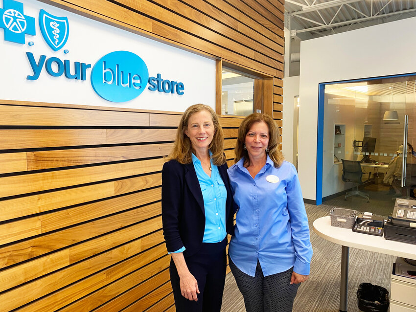 Martha Wofford, president and CEO of Blue Cross and Blue Shield of RI, on a visit to Your Blue Store in East Providence, with the store's receptionist, Melanie.