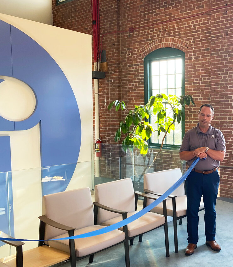 Dr. Michael Bradley, president and CEO of Ortho Ri, oversees the formal ribbon cutting of the newly redesigned interior of the Providence facility on Holden Street, part of the Foundry complex.