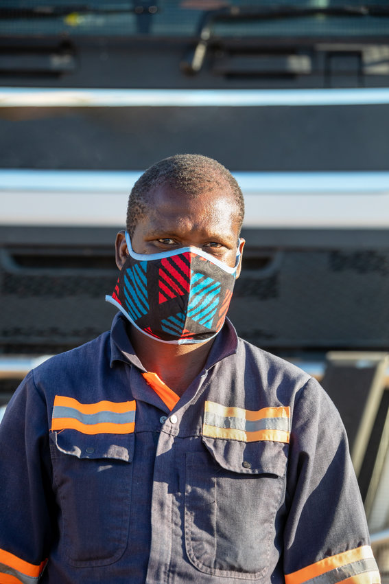 African truck driver wearing a face mask to avoid contamination
