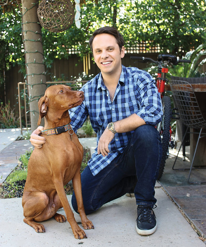 Daniel Nardinelli with McKinley, the office’s four-legged co-worker and companion 