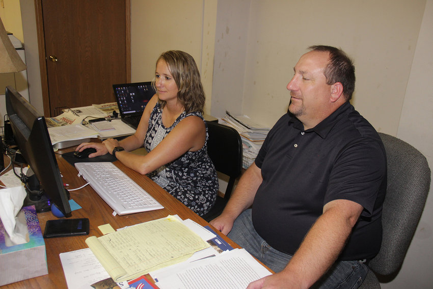 Publisher Tim Schmidt and Sales Manager Mandy Andrews meet in the Westplex Media Group's office.