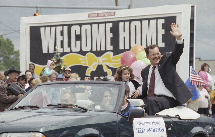 Former hostage Terry Anderson waves to the crowd as he rides in a parade in Lorain, Ohio, June 22, 1992. Anderson, the globe-trotting Associated Press correspondent who became one of America's longest-held hostages after he was snatched from a street in war-torn Lebanon in 1985 and held for nearly seven years, died Sunday, April 21, 2024.  He was 76. (AP Photo / Mark Duncan, File)