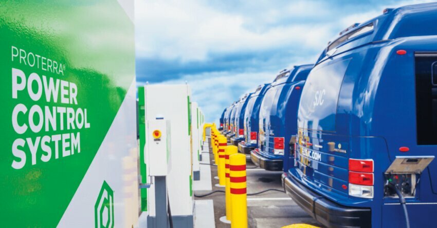 Proterra EV Charging Stations. Blue EV trucks plugged in to green and white charging stations