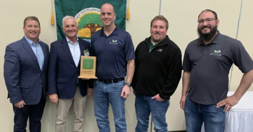 Five Men wearing dark shirts and jeans, holding an award.