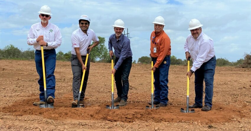 Five men holding shovels for a ground breaking ceremony