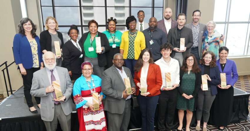 Diverse group of people holding 2023 Best of Green School Awards