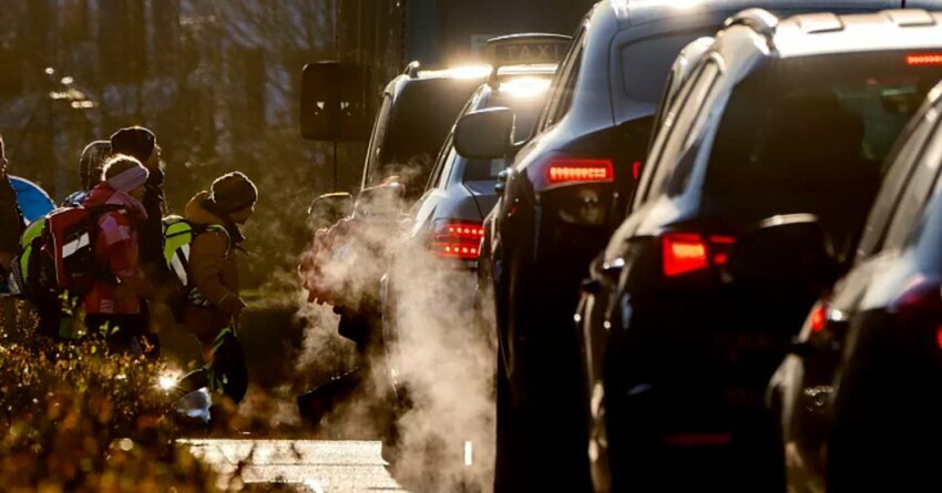 Cars give off exhaust fumes as children head to school in Frankfurt, Germany. Greenpeace Criticizes Germany and EU's Agreement on Combustion Engines