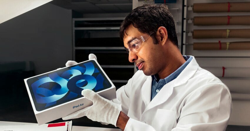 Apple product being examined by worker in white gloves. Recycled Cobalt