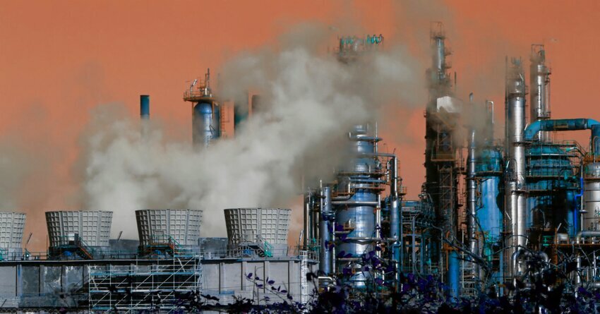Hazy smoke surrounds a factory.