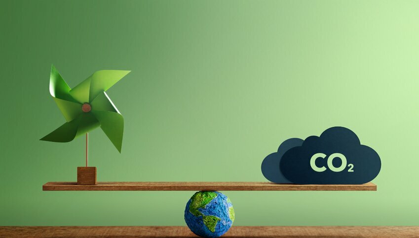 A green pinwheel and gray cloud with the letters CO2 balance on a seesaw. The seesaw's median is an image of the world.