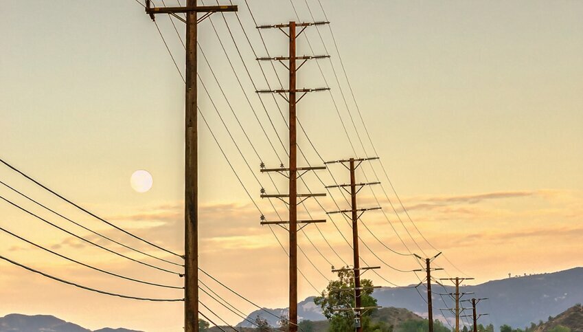 Utility lines against a yellow California sky.