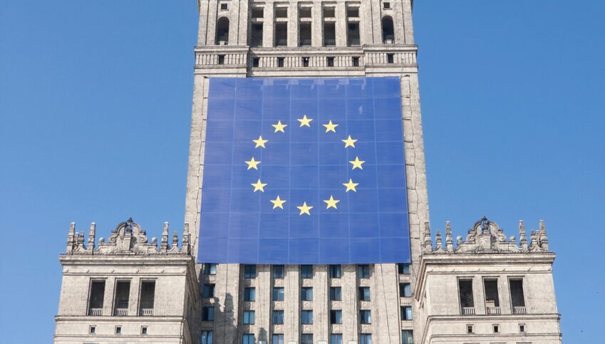 EU flag hangs from brick building