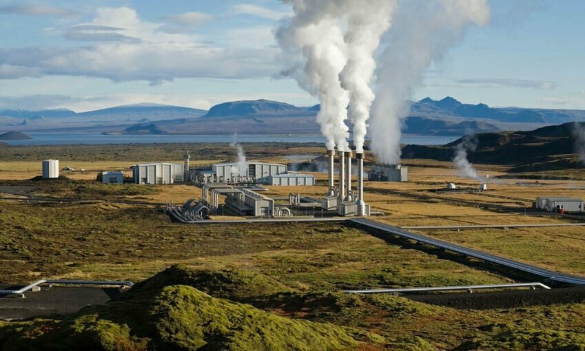 emissions rising from a power plant in the countryside