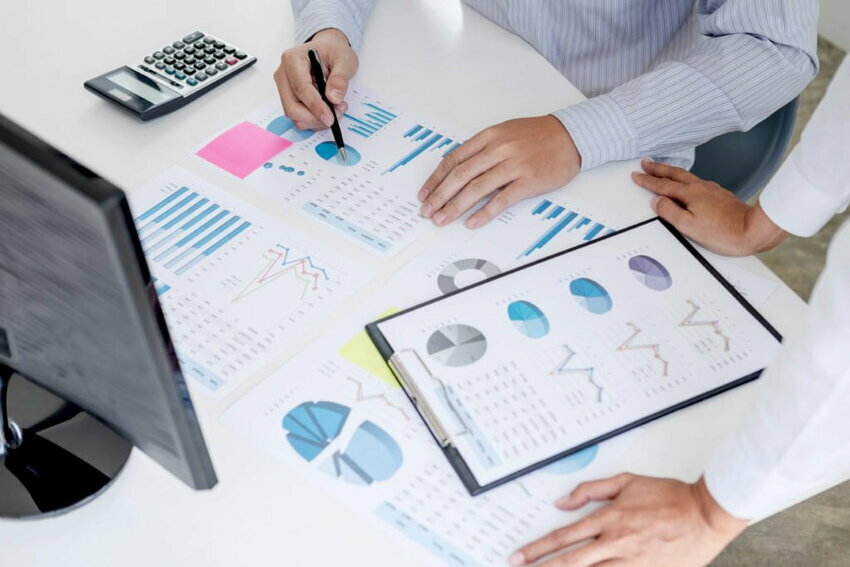 Business accountant or banker, business partner calculate and analysis with stock financial indices and financial costs wisely and carefully, investment and finance concept.