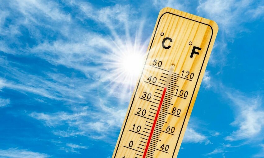 A thermometer showing hot temperatures with the sun in the background