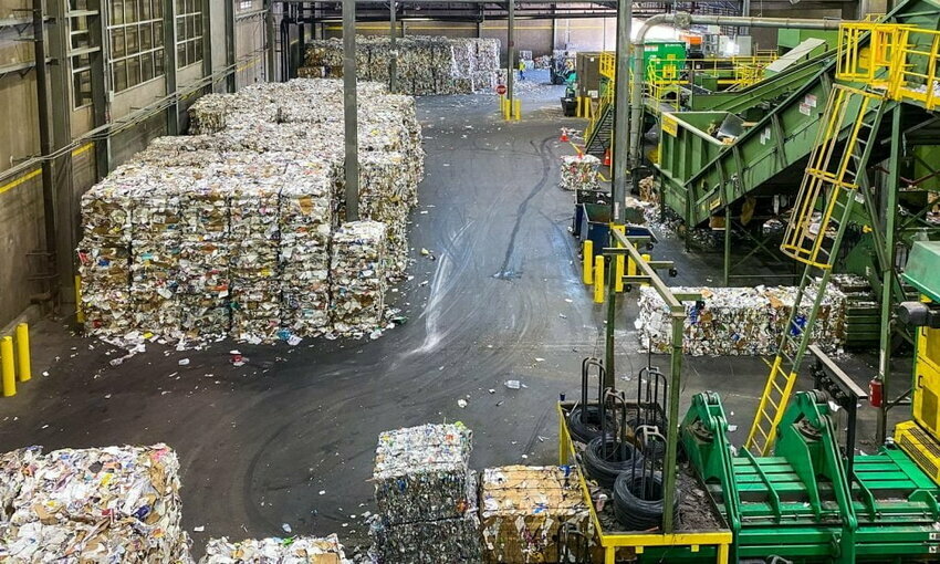 Stacks of paper and other waste at a recycling facility