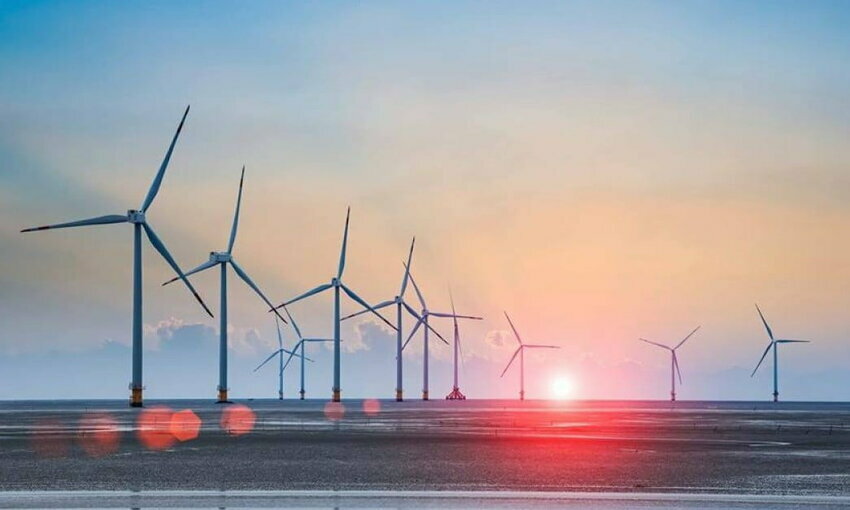 offshore wind turbines in a row on the ocean