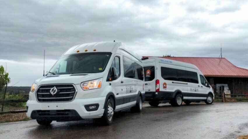 two white lightning ZEV3 vans are parked on pavement