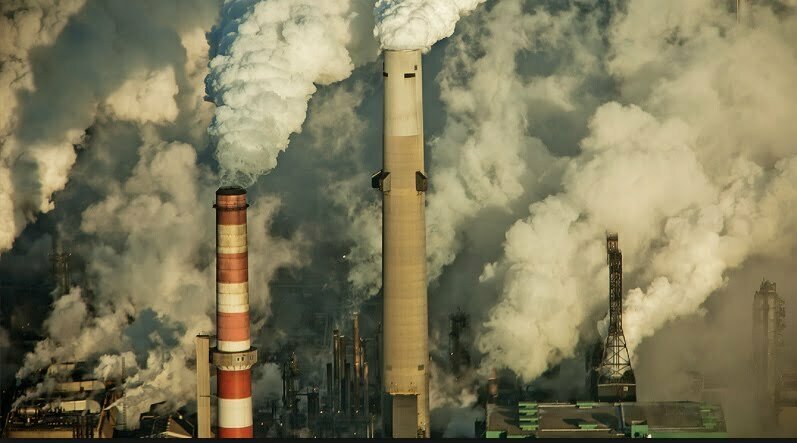 emissions coming from smoke stacks at an industrial facility.