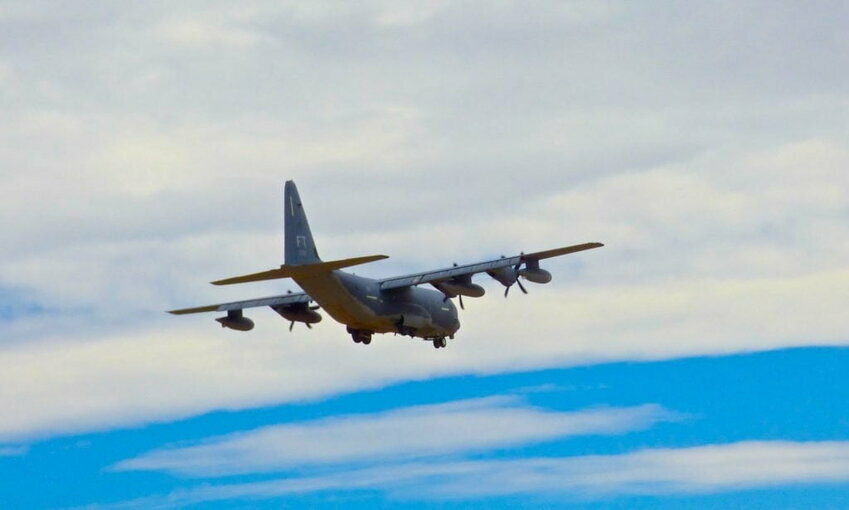 airplane flying in blue sky with clouds