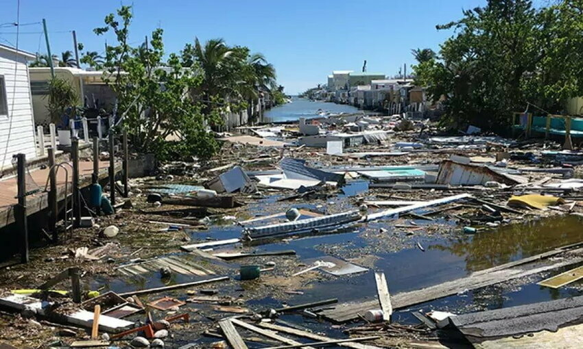 flood damage, high water levels in street with broken pieces of wood