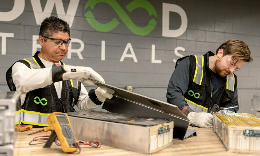 two men working at battery recycling plant