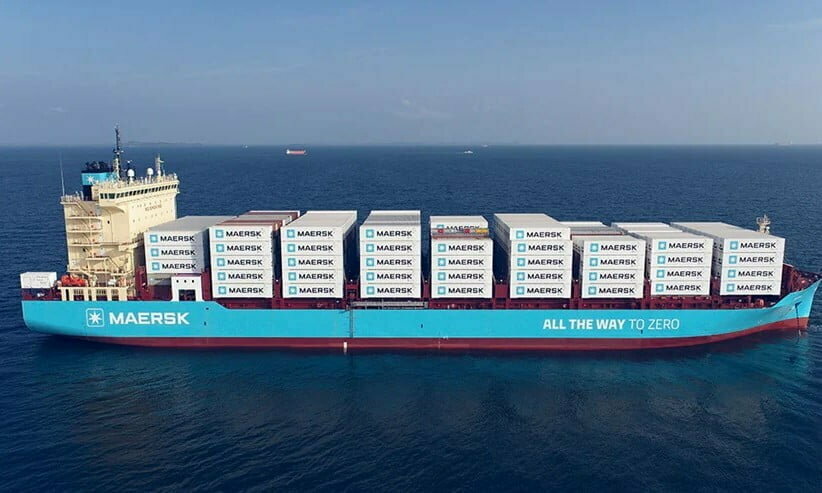 a maersk ship in the ocean with cargo containers on it.