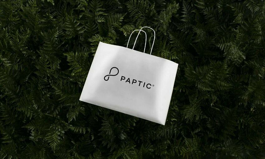 Paptic shopping bag in the middle of a bed of greenery