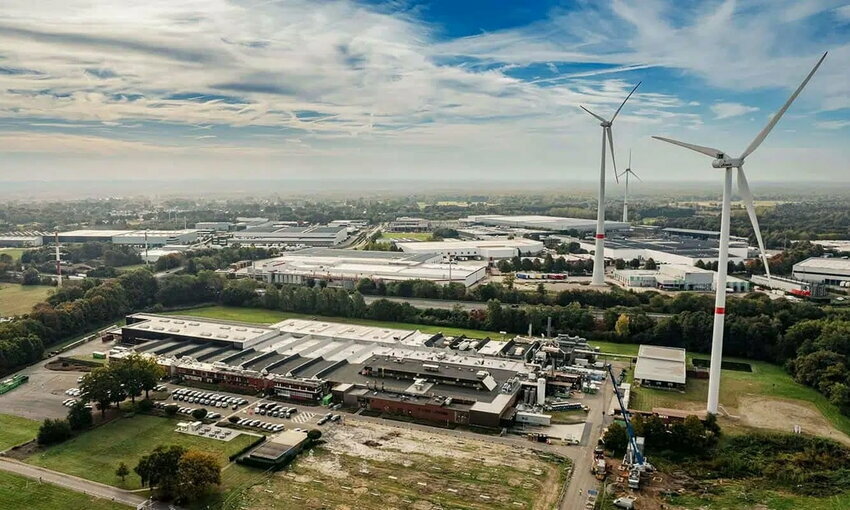 Avery Dennison factory under construction, outfitted with solar panels and wind turbines