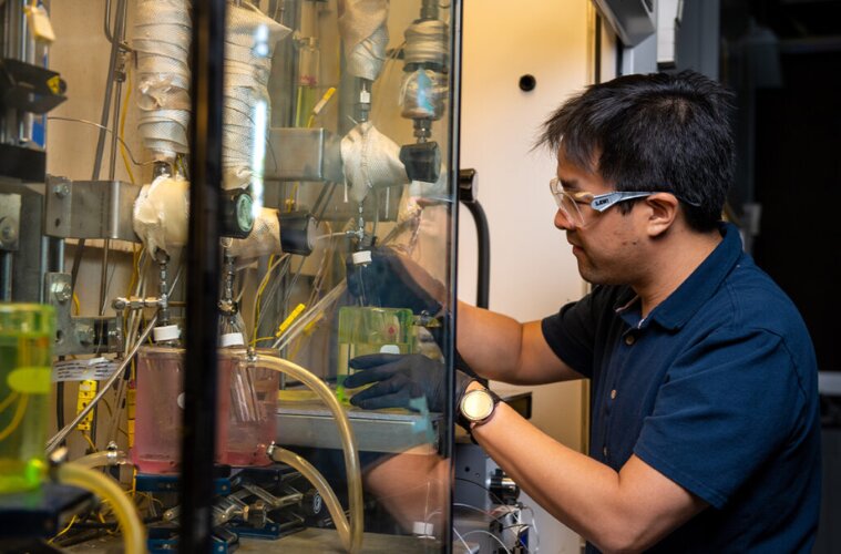 Working at Richland, Wash., Daniel Santosa, a Washington State University doctoral student and scientist at Pacific Northwest National Laboratory, tests a WSU-developed continuous process that turns lignin, a polymer found in plants, into jet fuel.