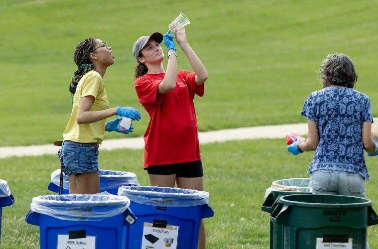 Kai-Lee Butler '27, left, and Jessica Janney '25, recycling coordinator with UMD's Facilities Management, examine the recycling code on a plastic cup at Friday's waste audit of McKeldin Library.