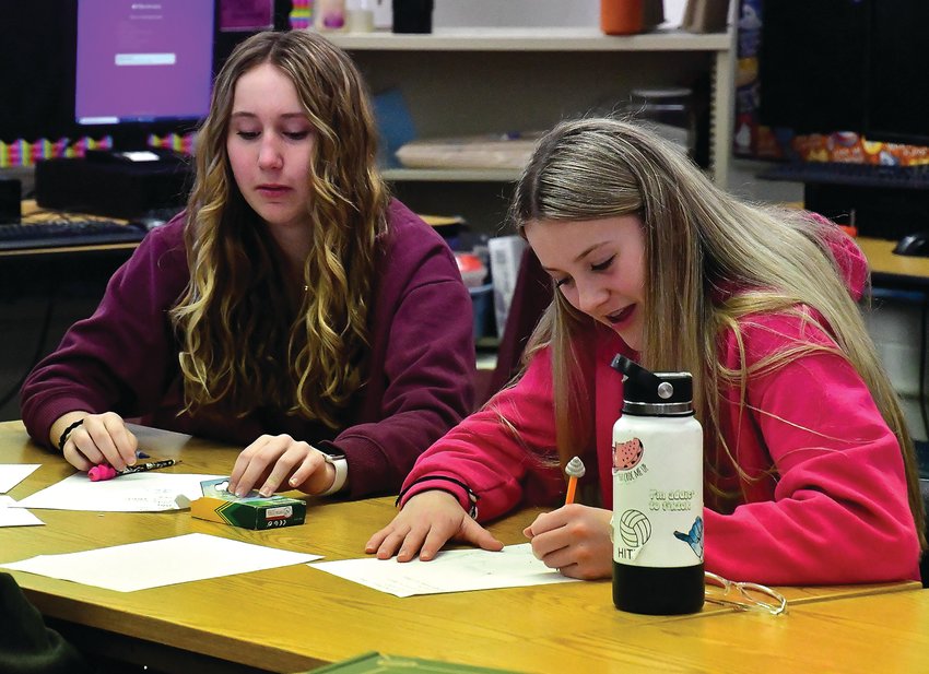 Leah Heller and Nevaeh Hauber take part in Introduce a Girl to Engineering Day on April 21. A small group of seventh-grade students worked with John Deere Dubuque Works representatives on a variety of projects to introduce them to the field of engineering. Student projects included designing a new backpack and putting together stereo headphones.