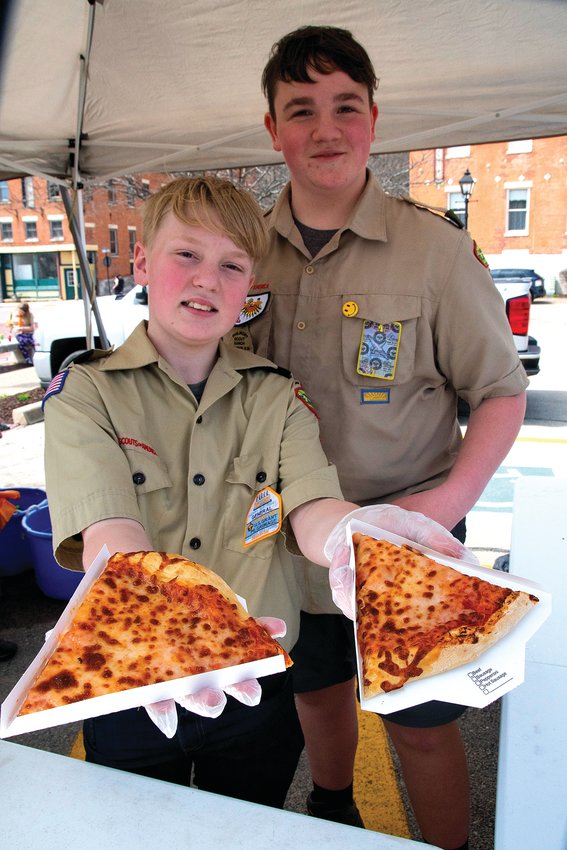 Tyson Scharpf and Quin Wells of Troop 95 from Galena serve up pizza at a food stand during the U.S. Grant Pilgrimage on Saturday, April 23. Thousands of boy scouts camped out and visited Galena and the surrounding area for the annual event.
