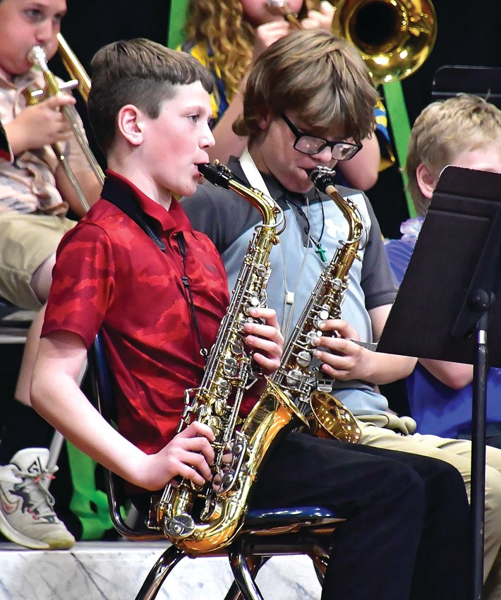 Scales Mound saxophone players Jonny Weis and Mason Virtue perform &lsquo;Baby Shark&rsquo; during the Scales Mound spring concert on May 10.