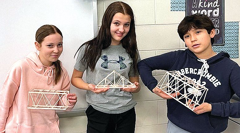 Sixth grade STEM students at River Ridge Middle School built balsa wood bridges in class. Students tested the bridges to see which was strongest, from left: Alexa Rowles, Jordan Ballard and Alex Navarro-Garcia.